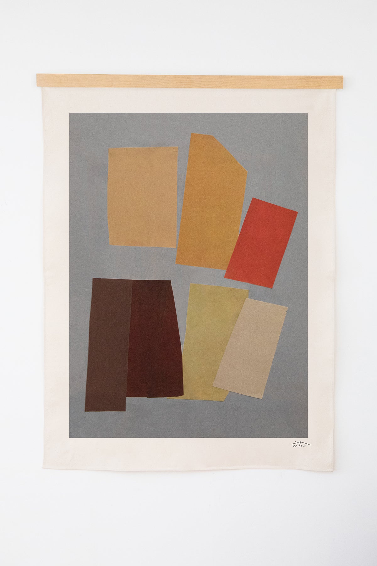 The Aluette is an original art print on 100% cotton canvas from Michael Upton. Featuring an abstract collage of overlapping geometric shapes in rich jewel tones, the Aluette is a large format modern wall hanging. Shown here with a wood hanging bar on a white background.