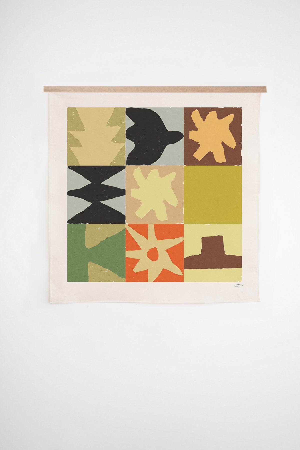 The Asaph is an original art print on 100% cotton canvas from Michael Upton. Featuring a geometric abstract mosaic design with bold colorful shapes, the Asaph is a large format modern wall hanging. Shown here with a wood hanging bar on a white background.