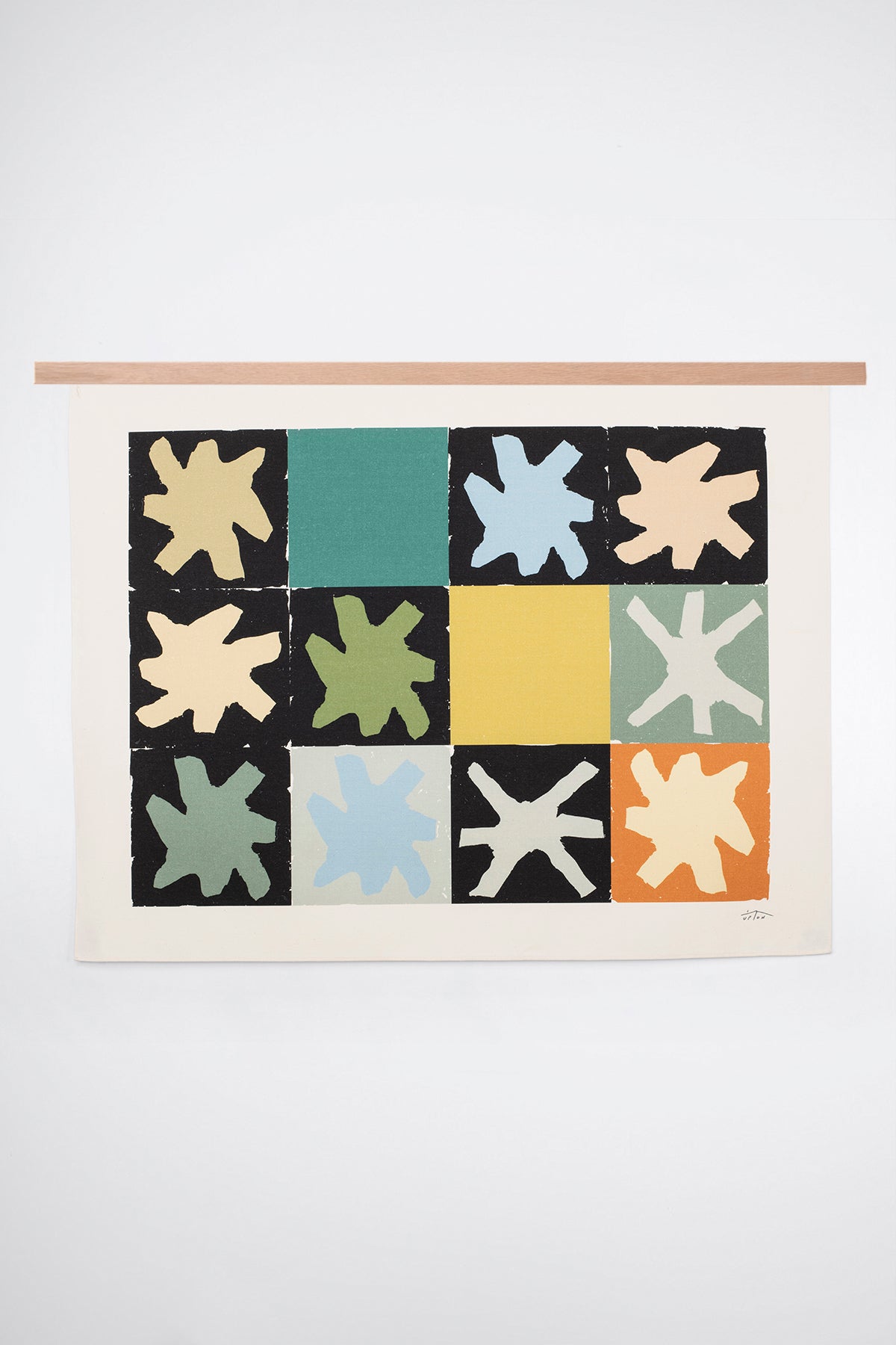 The Asterism is an original art print on 100% cotton canvas from Michael Upton. Featuring a geometric abstract mosaic design with bold colorful shapes, the Asterism is a large format modern wall hanging. Shown here with a wood hanging bar on a white background.