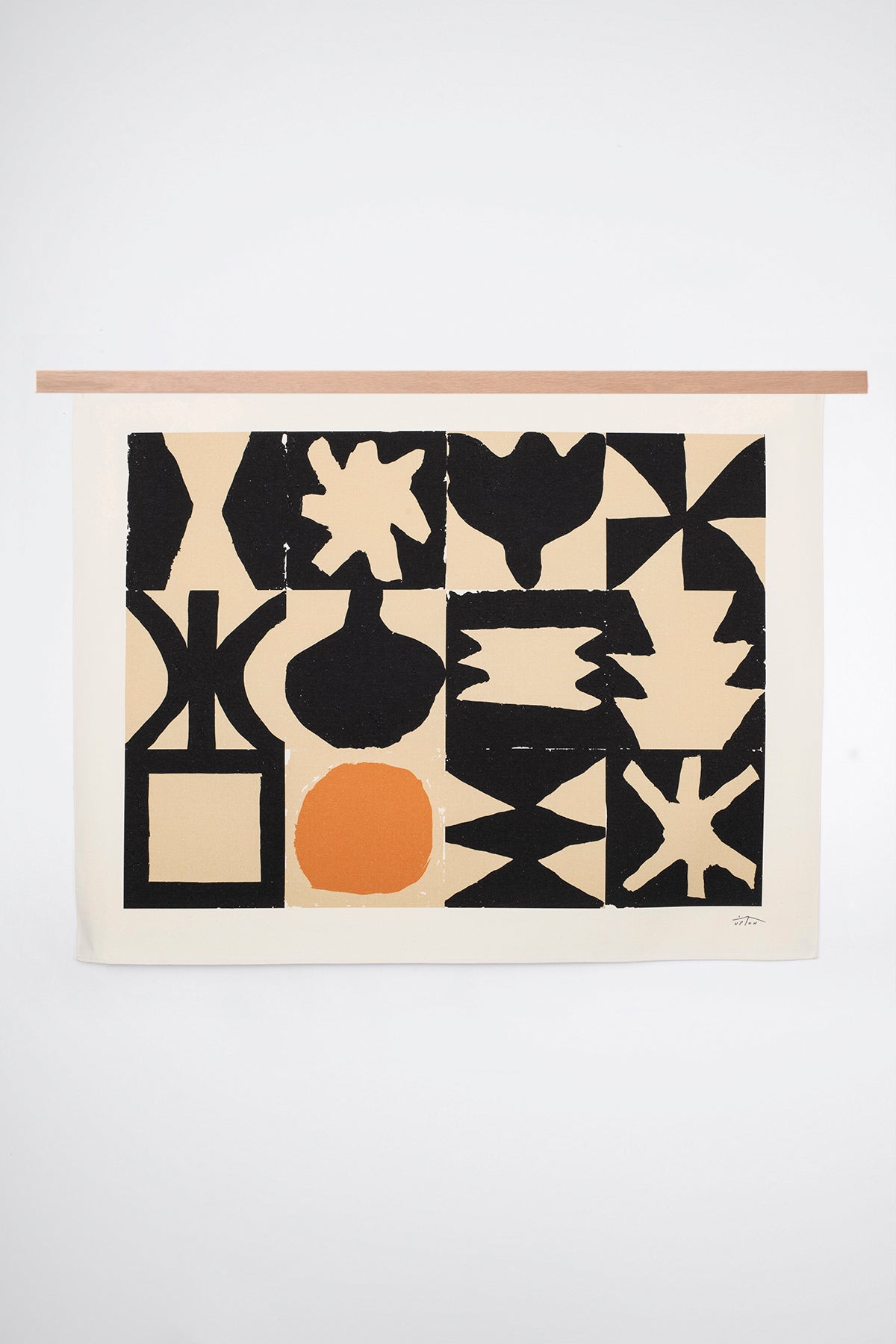 The Bedwa is an original art print on 100% cotton canvas from Michael Upton. Featuring a geometric abstract mosaic design with bold shapes, the Bedwa is a large format modern wall hanging. Shown here with a wood hanging bar on a white background.
