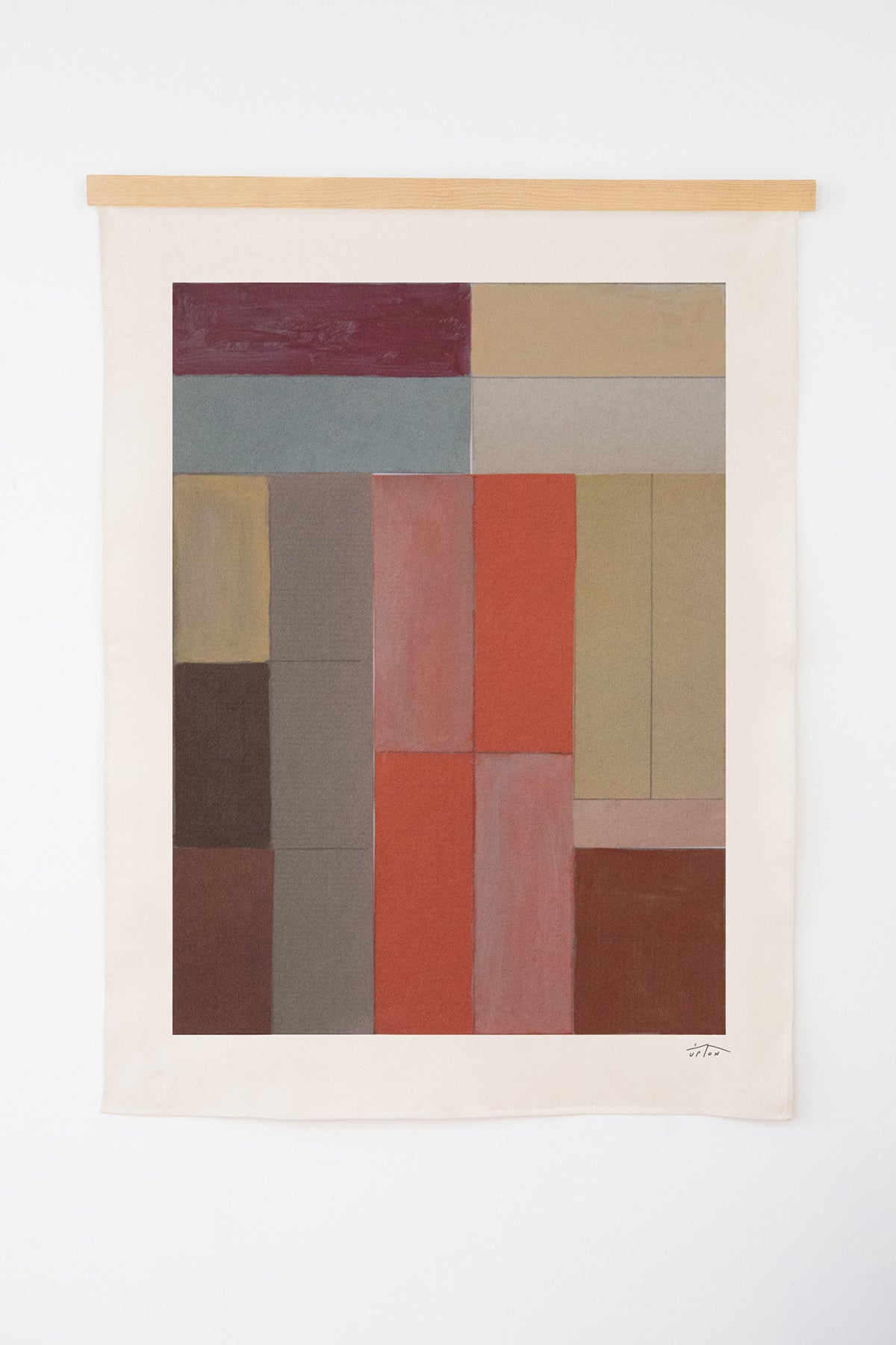 The Diam is an original art print on 100% cotton canvas from Michael Upton. Featuring an architectural abstract design in warm earth tones, the Diam is a large format modern wall hanging. Shown here on a white background with a wood hanging bar.