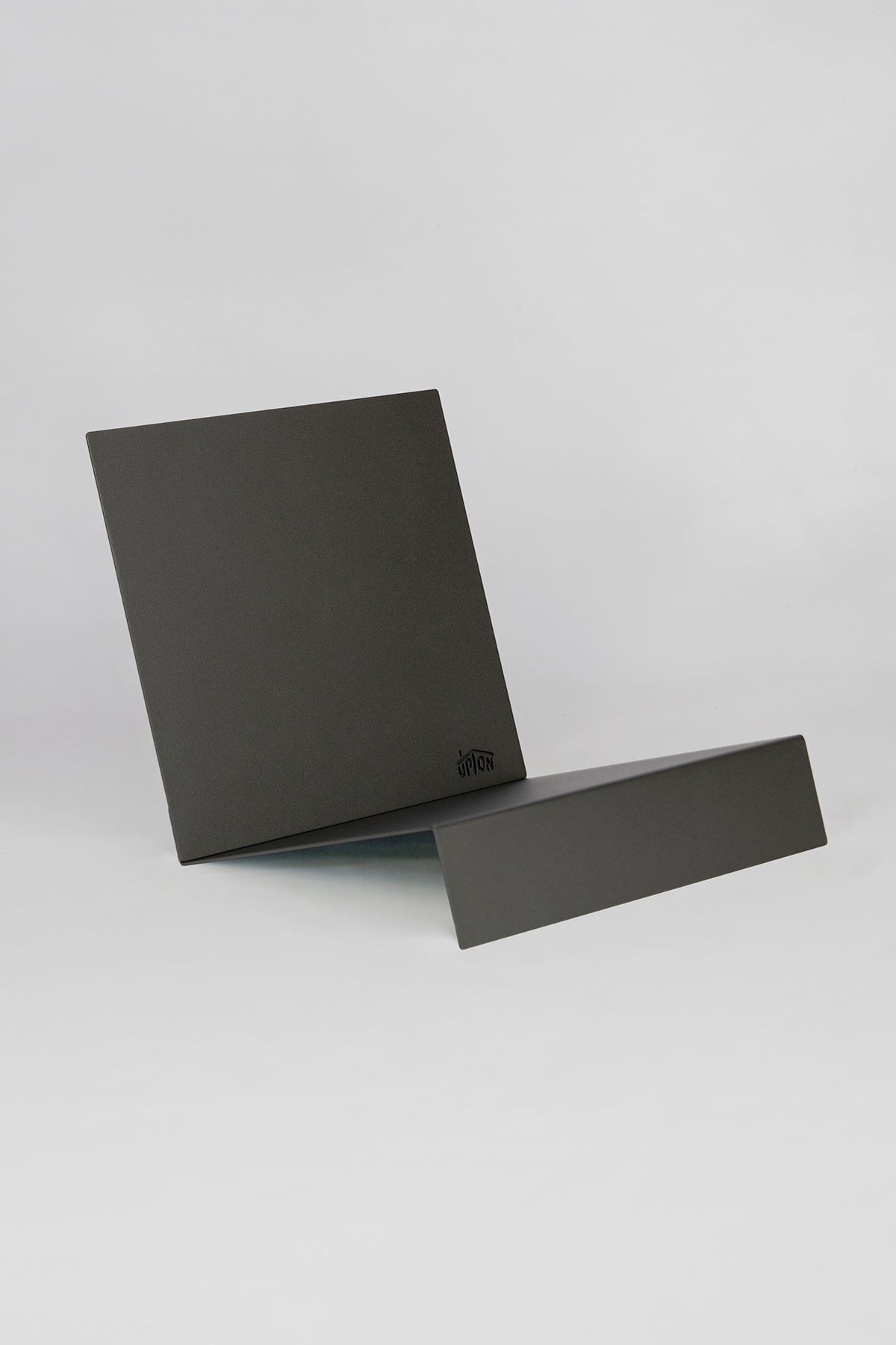 Upton LP Stand in black. Modern and minimalist tabletop steel vinyl record holder made for the storage, organization, and display 50 albums on a white background.