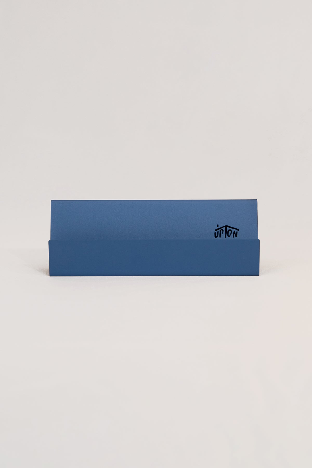 Upton Now Playing Stand in blue. Modern and minimalist steel display stand made to hold the record sleeve for the album currently playing on the turntable. Shown on a white background.