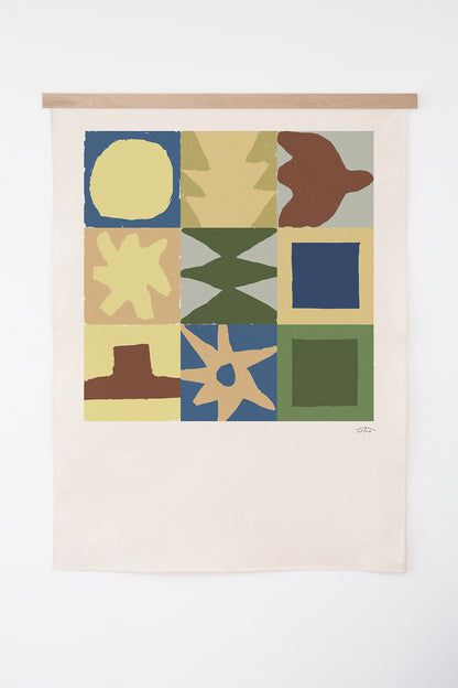 The Neath is an original art print on 100% cotton canvas from Michael Upton. Featuring a geometric abstract mosaic design with bold colorful shapes, the Neath is a large format modern wall hanging. Shown here with a wooden bar on a white background.