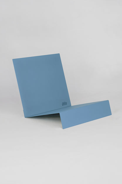 Upton LP Stand in blue. Modern and minimalist tabletop steel vinyl record holder made for storage, organization, and display of 50 albums on a white background.