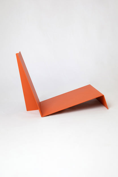 Upton LP Record Stand in burnt orange. Modern and minimalist tabletop steel vinyl record holder made for the storage, organization, and display 50 albums. Shown from the side on a white background.