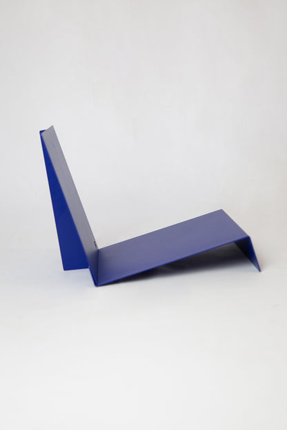 Upton LP Record Stand in cobalt blue. Modern and minimalist tabletop steel vinyl record holder made for the storage, organization, and display 50 albums. Shown here from the side on a white background.