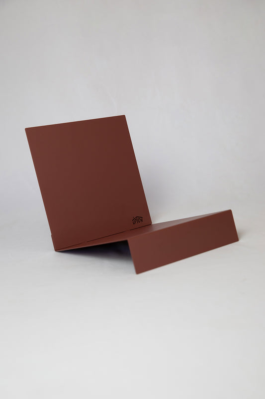 Upton LP Record Stand in rose (red / pink). Modern and minimalist tabletop steel vinyl record holder made for the storage, organization, and display 50 albums. Shown on a white background.