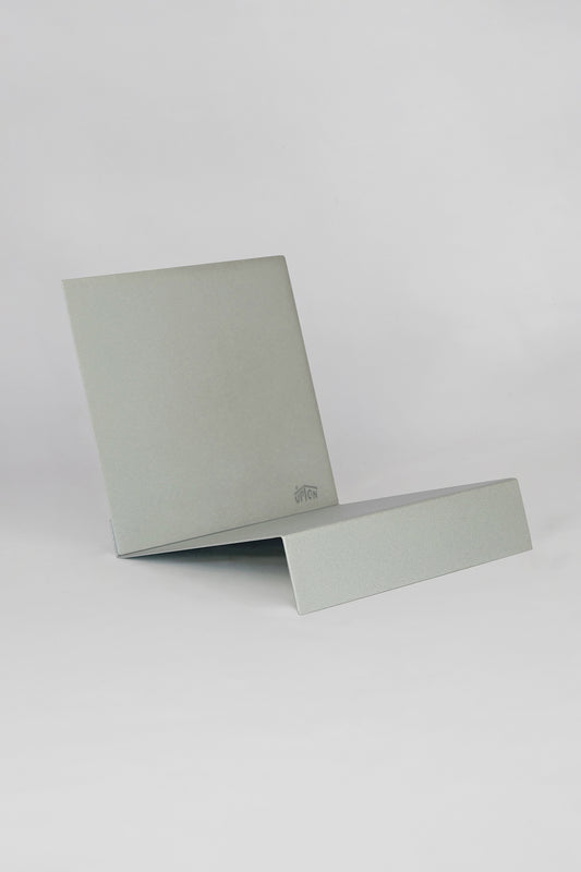 Upton LP Stand in silver. Sculptural steel storage and display stand made to hold records on a white background