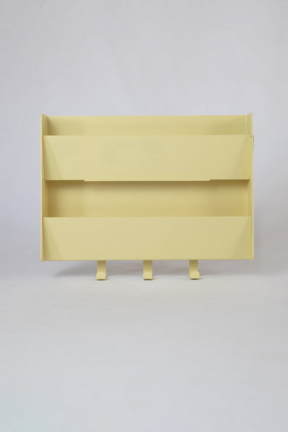 The Upton Mail Organizer in butter. Modern, minimalist, and design-forward wall-mounted mail organizer made of steel with a light yellow powder coat finish. Featuring two slots for mail and three sturdy hooks to hang keys, coats, bags, etc. Shown on a white background.