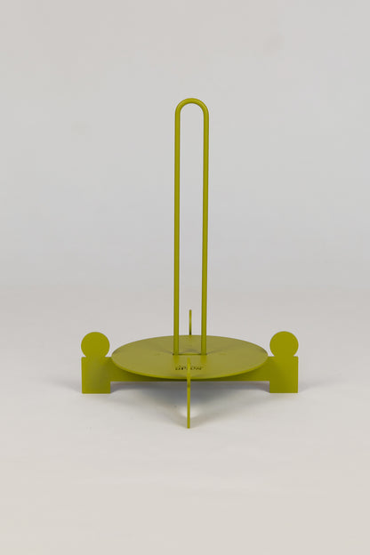 Upton Bal Paper Towel Holder. Green metal paper towel holder with circular base and vertical rod on a white background.