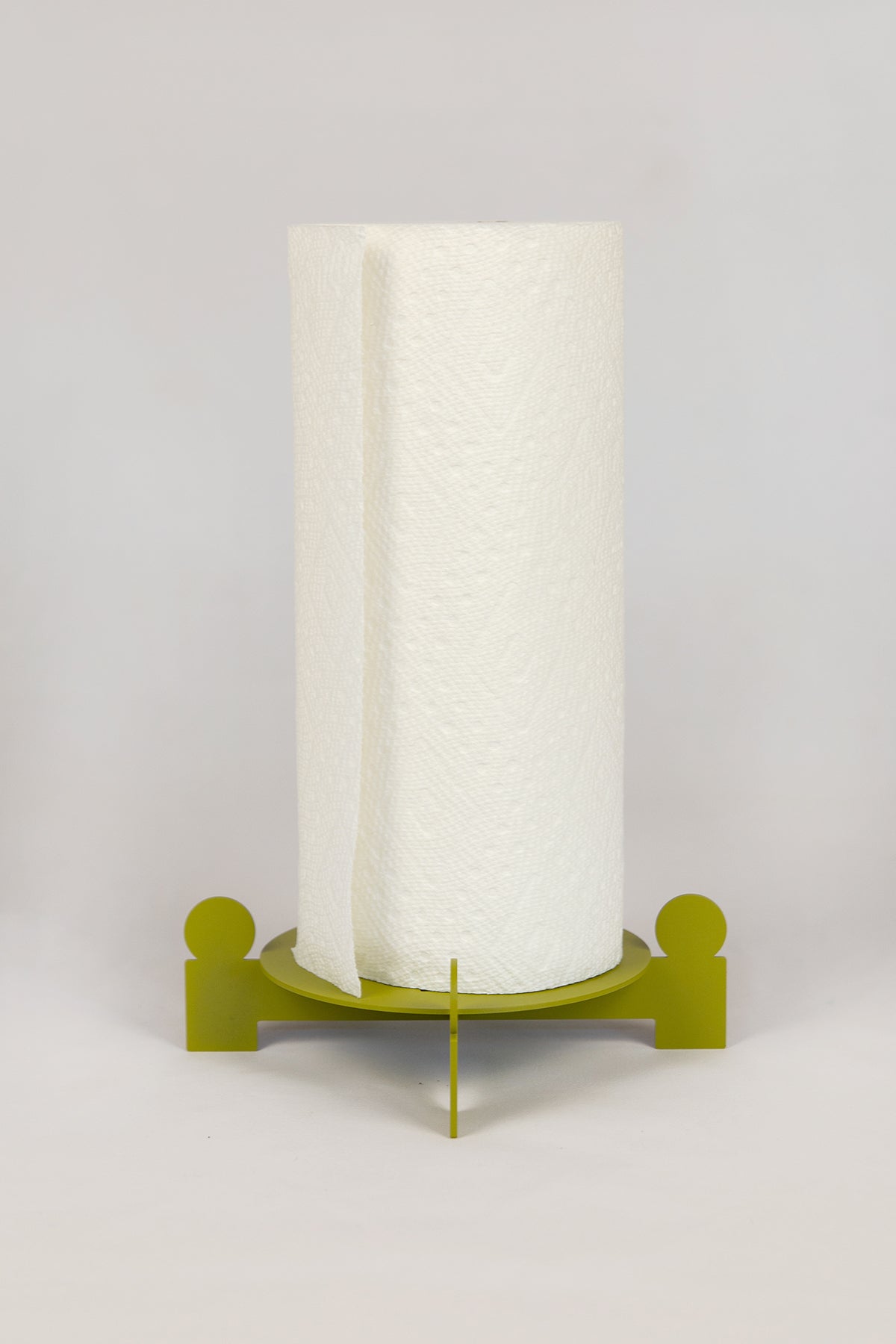 Upton Bal Paper Towel Holder. Green metal paper towel holder with circular base and vertical rod holding a paper towel roll on a white background.