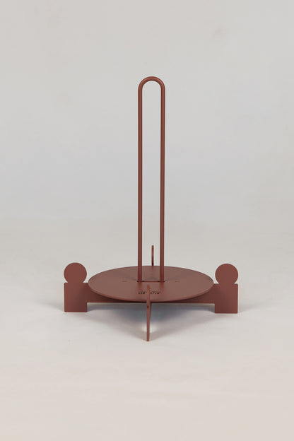 Upton Bal Paper Towel Holder in rose. Sculptural metal paper towel holder with circular base and vertical rod on a white background