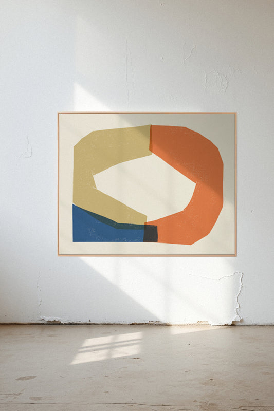 Enlace, a custom framed art print on 100% cotton canvas. Large abstract geometric block print in bold blue, golden yellow, and reddish orange in a gallery setting.