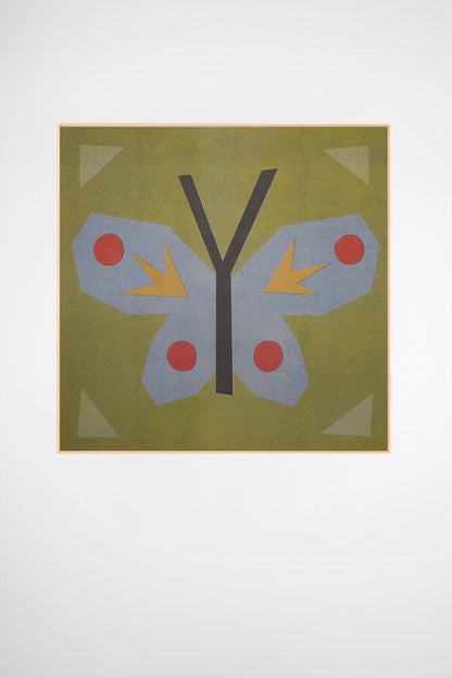 Butterfly Stamp by Sunroom Studios x Upton, a custom framed art print on 100% cotton canvas. Large cut paper collage of a butterfly on an olive green background, with light blue, red, and yellow accents. Originally created as a risograph print. Shown on a white background.