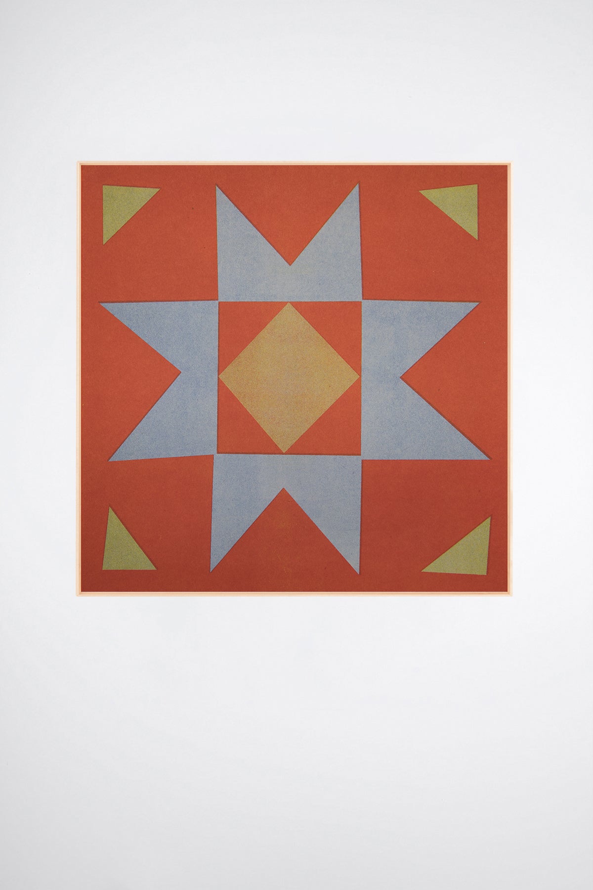 Quilt Stamp by Sunroom Studios x Upton, a custom framed art print on 100% cotton canvas. Large cut paper collage of a geometric starburst quilt pattern in terracotta red, light blue-gray, pale yellow, and olive green. Originally created as a risograph print. Shown on a white background.