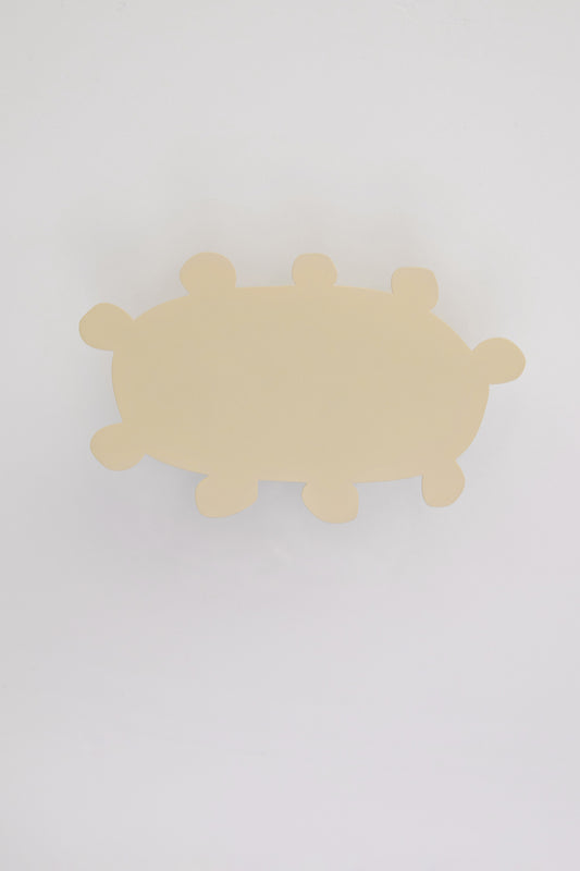 Upton Soli Wall Hook in butter. A sculptural decorative steel wall hook with a butter yellow color scheme with a unique abstract shape, designed to hang bags, coats, towels, hats, and more. Shown here on a white background.